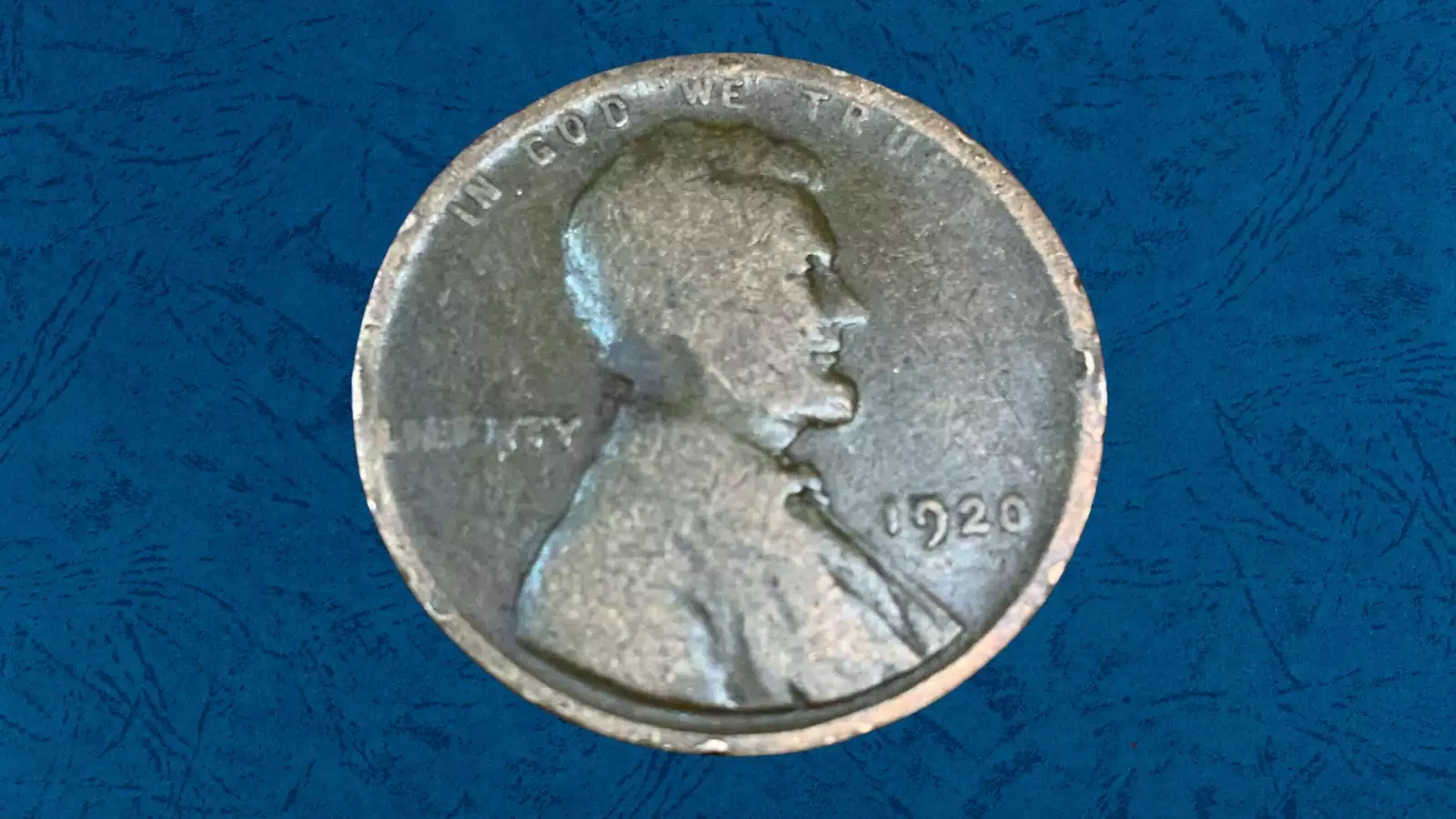 1920 wheat penny struck on a Cuban centavo planchet showing smaller diameter, peach and gray copper-nickel coloration and truncated legends